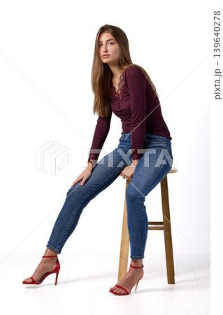 Slavic fashion model seated in studio portrait Slavic fashion model seated in studio portrait 139640278