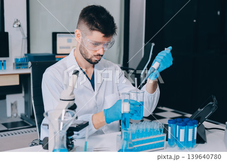 Lab technician experimenting in lab 139640780