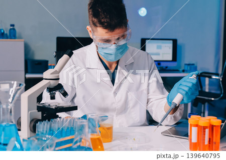 Lab technician experimenting in lab 139640795