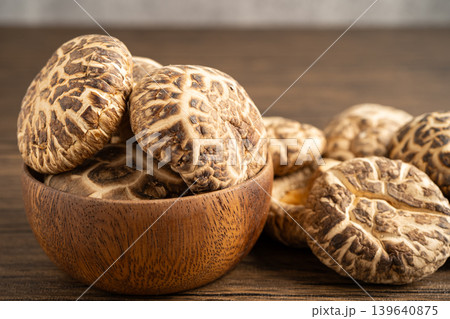 Dried shiitake mushroom in woodle bowl, healthy food. Dried shiitake mushroom in woodle bowl, healthy food. 139640875
