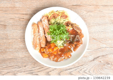 grilled pork steak dressing sweet and sour gravy stew sauce with spaghetti and chop cabbage salad couple sausage on plate grilled pork steak dressing sweet and sour gravy stew sauce with spaghetti and chop cabbage salad couple sausage on plate 139642239
