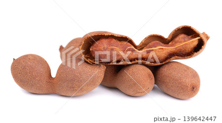 Fresh tamarind pods and open shell with pulp isolated on white background. Fresh tamarind pods and open shell with pulp isolated on white background. 139642447