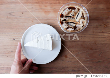 coconut cake or coconut mousse cake and iced coffee , iced latte coffee or iced cappuccino coffee coconut cake or coconut mousse cake and iced coffee , iced latte coffee or iced cappuccino coffee 139643159
