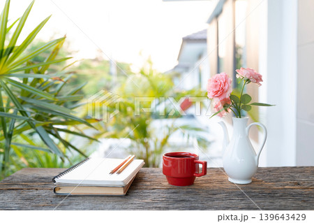 Notebooks and pencil, Cozy writing and red coffee with vase of pink 139643429