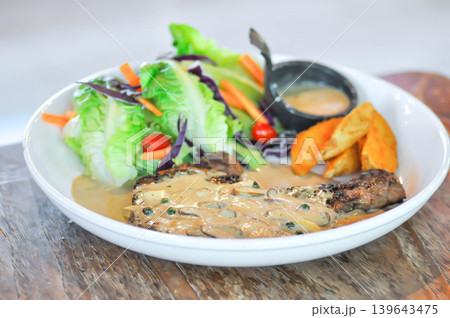 pork steak or grilled pork and salad or pork chop with fried potato and vegetable pork steak or grilled pork and salad or pork chop with fried potato and vegetable 139643475