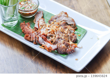fried pork with fried garlic , fried pork or sliced pork with dip or chili sauce fried pork with fried garlic , fried pork or sliced pork with dip or chili sauce 139643824