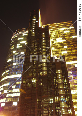 skyscraper skyscraper tall building at night illuminated with office lights skyscraper skyscraper tall building at night illuminated with office lights 139643945