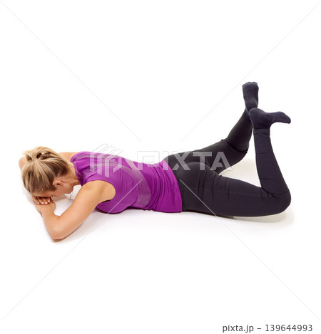 Pilates, woman and stretching thighs, hips and glutes on the floor in white background of studio. Yoga, exercise and person workout for legs on ground with feet raised in the air in pose for fitness Pilates, woman and stretching thighs, hips and glutes on the floor in white background of studio. Yoga, exercise and person workout for legs on ground with feet raised in the air in pose for fitness 139644993