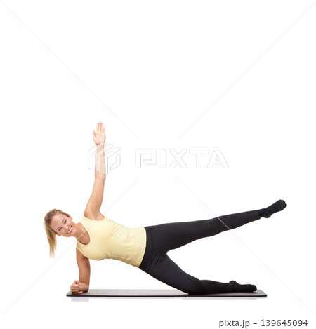 Woman, yoga and mat in studio for side plank, fitness or workout for healthy body, happy or core muscle. Person, portrait and pilates on floor for abdomen health on mockup space or white background Woman, yoga and mat in studio for side plank, fitness or workout for healthy body, happy or core muscle. Person, portrait and pilates on floor for abdomen health on mockup space or white background 139645094