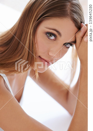 Beauty, makeup and portrait of young woman with shine, glow and glamour facial routine. Confidence, cosmetics and serious attractive female person with self care, dermatology and face treatment. Beauty, makeup and portrait of young woman with shine, glow and glamour facial routine. Confidence, cosmetics and serious attractive female person with self care, dermatology and face treatment. 139645280