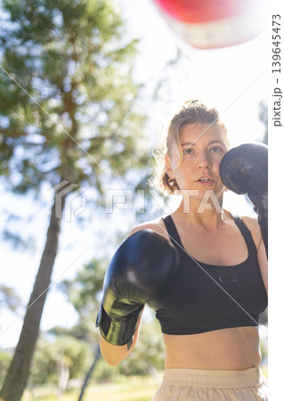 Woman training boxing outdoors for fitness and strength Woman training boxing outdoors for fitness and strength 139645473