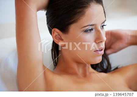 Bath, home and face of woman washing, grooming and self care cleaning for hygiene, cleanse and wellness. Body hydration, bathroom and relax person with wet hair, beauty or skincare in bathtub 139645707