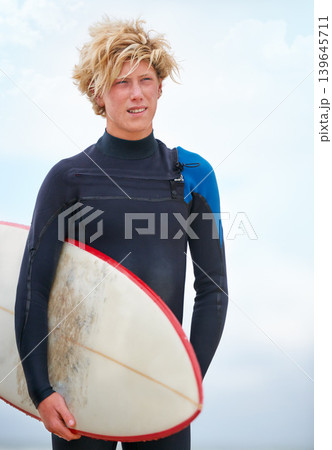 Surfer, teen boy on beach and surfboard, holiday and adventure for fitness and travel outdoor. Summer, athlete and surfing on seaside vacation in Hawaii, nature and tourism with extreme sports 139645711