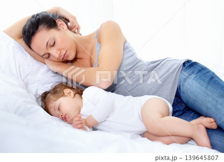 Mother, baby and sleeping on bed together for calm break, peace and dreaming to relax at home. Tired mom, young kid and asleep for newborn development, healthy childhood growth and cozy nap for rest Mother, baby and sleeping on bed together for calm break, peace and dreaming to relax at home. Tired mom, young kid and asleep for newborn development, healthy childhood growth and cozy nap for rest 139645807