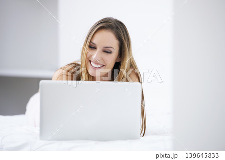 Happy woman, bedroom and laptop for planning, search on website and registration or streaming at home. Young person relax on bed with computer for morning news, social media update or reading blog 139645833