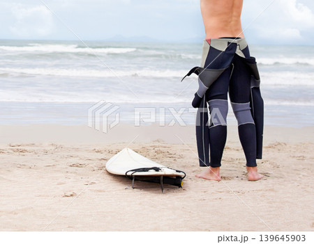Beach, body or ready to start surfing with surfboard on vacation or adventure for fitness or travel. Back view of athlete, swimwear or man at seaside on holiday in Hawaii or ocean in extreme sports Beach, body or ready to start surfing with surfboard on vacation or adventure for fitness or travel. Back view of athlete, swimwear or man at seaside on holiday in Hawaii or ocean in extreme sports 139645903