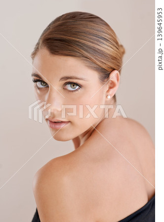Portrait, beauty and serious woman in studio isolated on a brown background. Face, shoulder and young model shine in cosmetics, healthy skin glow and spa facial treatment for skincare dermatology Portrait, beauty and serious woman in studio isolated on a brown background. Face, shoulder and young model shine in cosmetics, healthy skin glow and spa facial treatment for skincare dermatology 139645953