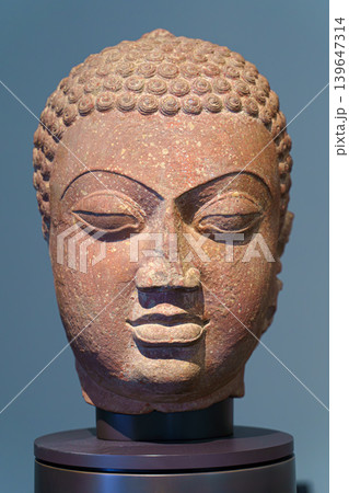 Abu Dhabi, United Arab Emirates - Jan 17 2024, close up view of the ancient head of the statue of a budda, on exhibition of museum Louvre Abu Dhabi, UAE Abu Dhabi, United Arab Emirates - Jan 17 2024, close up view of the ancient head of the statue of a budda, on exhibition of museum Louvre Abu Dhabi, UAE 139647314