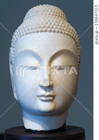 Abu Dhabi, United Arab Emirates - Jan 17 2024, close up view of the ancient head of the statue of a budda, on exhibition of museum Louvre Abu Dhabi, UAE 139647315