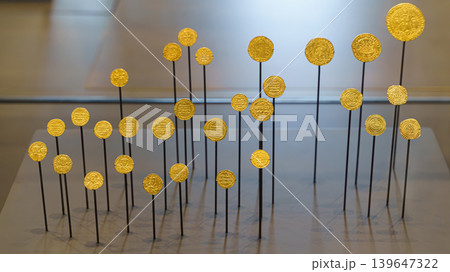 Abu Dhabi, United Arab Emirates - Jan 17 2024, close up view of ancient gold coins mounted on stands, on exhibition of museum Louvre Abu Dhabi, UAE 139647322