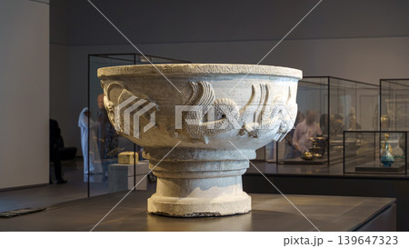 Abu Dhabi, United Arab Emirates - Jan 17 2024, close-up view of a marble bowl with the carved name of Bonifilius and the image of wild animals, on exhibition of Museum Louvre Abu Dhabi, UAE 139647323