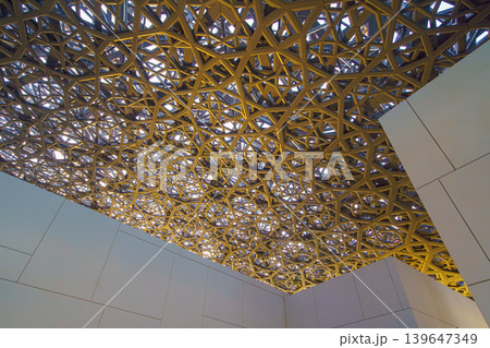Abu Dhabi, United Arab Emirates - Jan 17 2024, Panoramic view of the metallic dome and buildings of the Louvre Abu Dhabi Museum, at daytime, Abu Dhabi, United Arab Emirates  139647349
