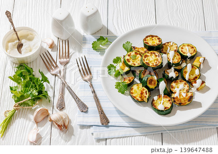 Fried zucchini with garlic yogurt sauce on plate Fried zucchini with garlic yogurt sauce on plate 139647488