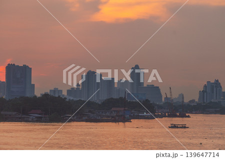 Bangkok skyline at sunset with Chao Phraya River and boat traffic Bangkok skyline at sunset with Chao Phraya River and boat traffic 139647714