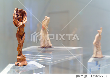 Abu Dhabi, United Arab Emirates - Jan 17 2024, close up view of the ancient statuettes of woman, at exhibition of the Louvre Abu Dhabi, UAE Abu Dhabi, United Arab Emirates - Jan 17 2024, close up view of the ancient statuettes of woman, at exhibition of the Louvre Abu Dhabi, UAE 139647795