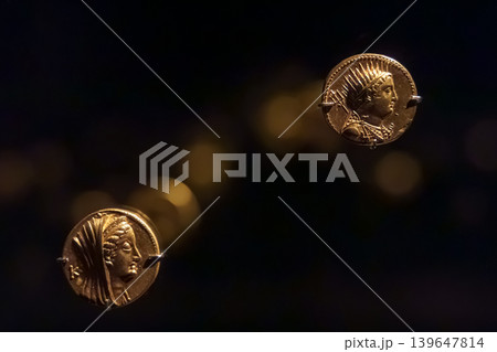 Abu Dhabi, United Arab Emirates - Jan 17 2024, Close-up view of the ancient antique coins in the Louvre Abu Dhabi Museum, belonging to different eras, Abu Dhabi, United Arab Emirates Abu Dhabi, United Arab Emirates - Jan 17 2024, Close-up view of the ancient antique coins in the Louvre Abu Dhabi Museum, belonging to different eras, Abu Dhabi, United Arab Emirates 139647814