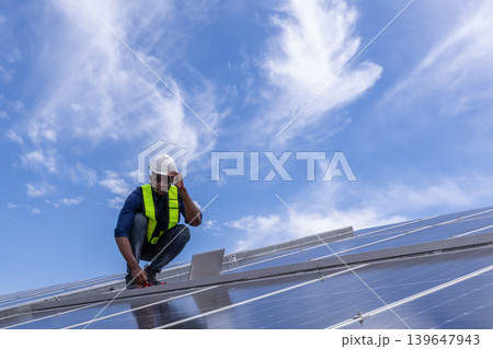 Engineer service check installation solar cell on the roof of factory. Engineer service check installation solar cell on the roof of factory. 139647943
