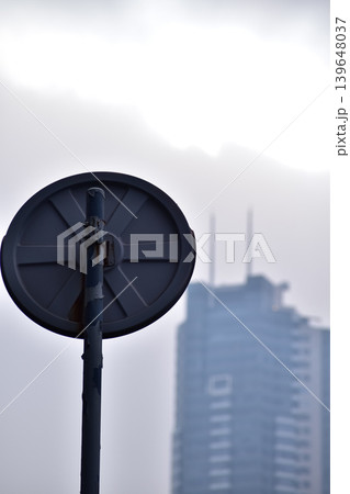 Close-up of the back of the road sign in Hong Kong with the blurred buildings in the background. Hong Kong Cityscape. Close-up of the back of the road sign in Hong Kong with the blurred buildings in the background. Hong Kong Cityscape. 139648037
