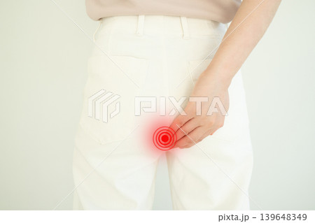 Woman suffering from anal pain and discomfort. Cause of pain include hemorrhoid, anal fissure, diarrhea, constipation or Crohn's disease. Gastrointestinal system concept. 139648349