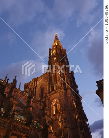 Phone photo of Strasbourg Cathedral at twilight dusk. Dramatic Gothic architecture silhouetted against blue hour sky in a historic European city. Phone photo of Strasbourg Cathedral at twilight dusk. Dramatic Gothic architecture silhouetted against blue hour sky in a historic European city. 139649266