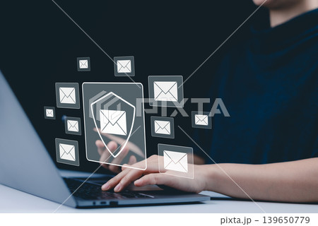 Email security and protection technology concept. A woman using a laptop and phone, with virtual email icons and shield symbolizing data security and communication protection. cybersecurity threats, 139650779