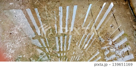Abstract reflection of a fence in a puddle 139651169