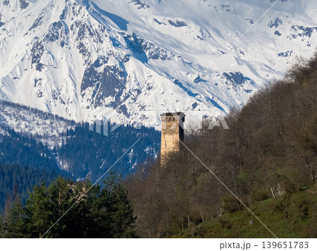 Ancient tower stands lone against snow-capped peaks Ancient tower stands lone against snow-capped peaks 139651783