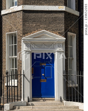 Blue Door of Georgian Townhouse With Ornate White Doorway and Brick Facade in London Blue Door of Georgian Townhouse With Ornate White Doorway and Brick Facade in London 139652093