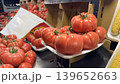 Heirloom tomatoes fill the market, boasting vibrant colors that invite shoppers to savor their freshness. 139652663