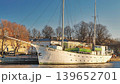 Porvoo, Finland - December 08, 2020: Historic sailing ship is docked by the waterfront, surrounded by trees and buildings, showcasing maritime heritage and urban scenery 139652701