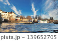 Porvoo, Finland - December 08, 2020: Scenic waterfront view features boats docked along the shore, with a vibrant blue sky and wispy clouds creating a picturesque atmosphere 139652705