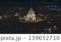 Porvoo, Finland - December 08, 2020: Aerial view of a historic church illuminated at night, surrounded by a charming town, showcasing architectural beauty and serene ambiance 139652710