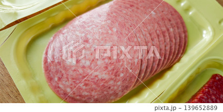 Slices of deli meat arranged neatly in a yellow plastic tray for easy access Slices of deli meat arranged neatly in a yellow plastic tray for easy access 139652889