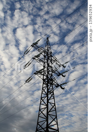 Vertical Image of Single Metal Power Line Tower Under Cloudy Sky Vertical Image of Single Metal Power Line Tower Under Cloudy Sky 139652934