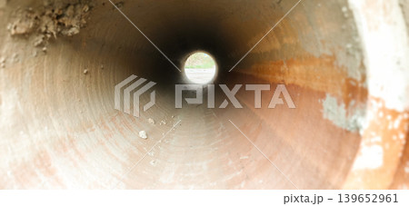 Construction of concrete pipes inside a work site during daylight hours Construction of concrete pipes inside a work site during daylight hours 139652961