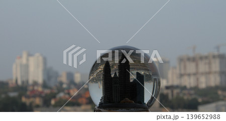 Miniature skyscrapers inside a souvenir crystal ball with reflection of a real cityscape inside Miniature skyscrapers inside a souvenir crystal ball with reflection of a real cityscape inside 139652988