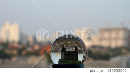 Miniature castle in toy glass globe with real cityscape soft focus 139652992