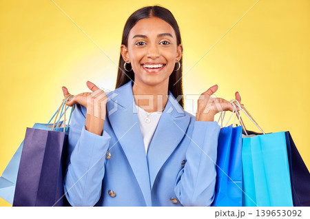 Business woman, shopping bag and studio portrait with smile, success or deal by yellow background. Happy customer experience, gift and discount with retail therapy, sale or excited for fashion choice Business woman, shopping bag and studio portrait with smile, success or deal by yellow background. Happy customer experience, gift and discount with retail therapy, sale or excited for fashion choice 139653092