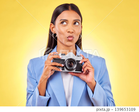 Pouting, thinking and a woman with a camera on a yellow background for a photography idea. Happy, photographer or a person with gear for paparazzi, press or a journalist employee for pictures 139653109