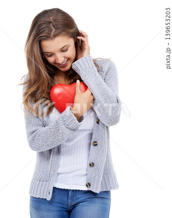 Red heart, smile and shy woman in studio for love, care and romance, affection or support on white background. Shape, flirt and female model with symbol, sign or icon for valentines day celebration Red heart, smile and shy woman in studio for love, care and romance, affection or support on white background. Shape, flirt and female model with symbol, sign or icon for valentines day celebration 139653203